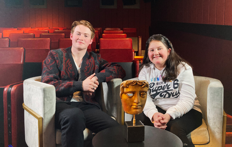 Actor, Kit Connor, sitting with BAFTA Young Presenter Gracie