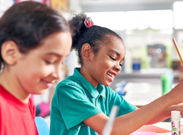 2 students doing work in a classrom