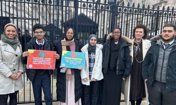 A group of 5 politics students from Ark King Soloman Academy, standing outside Downing Street with their teacher and CEO of Place2Be, Catherin Roche