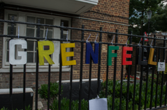 School gate showing colourful letters spelling out 'Grenfell'