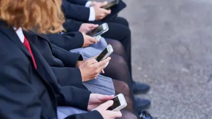 Young people looking at their mobile phones