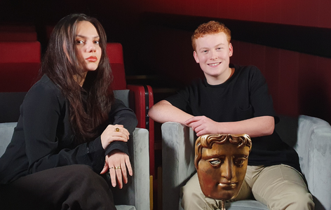 Actress, Dafne Keen, sitting with BAFTA Young Presenter Braydon