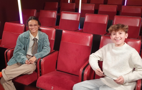 BAFTA Young Presenter Tristan Thompson with actor Chloe Lea, sitting on red theatre seats