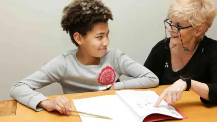 Child and grandparent doing homework