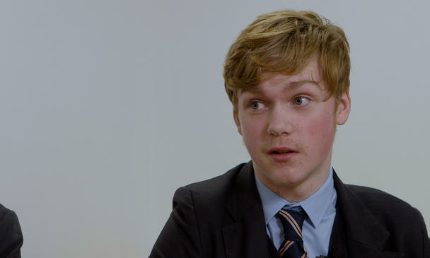 Secondary-aged pupil talking to others