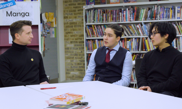Josh Smith talking to secondary-aged pupils in a school library