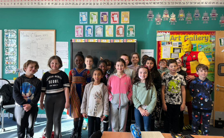 A small class standing in different costumes for Dress to Express