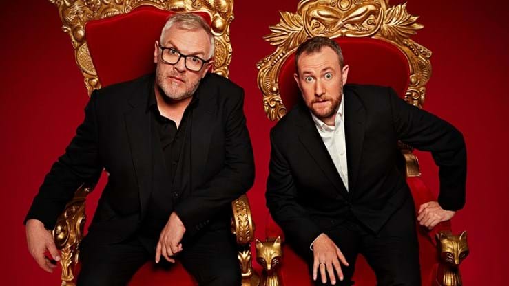 Taskmaster presenters in red and gold throne chairs